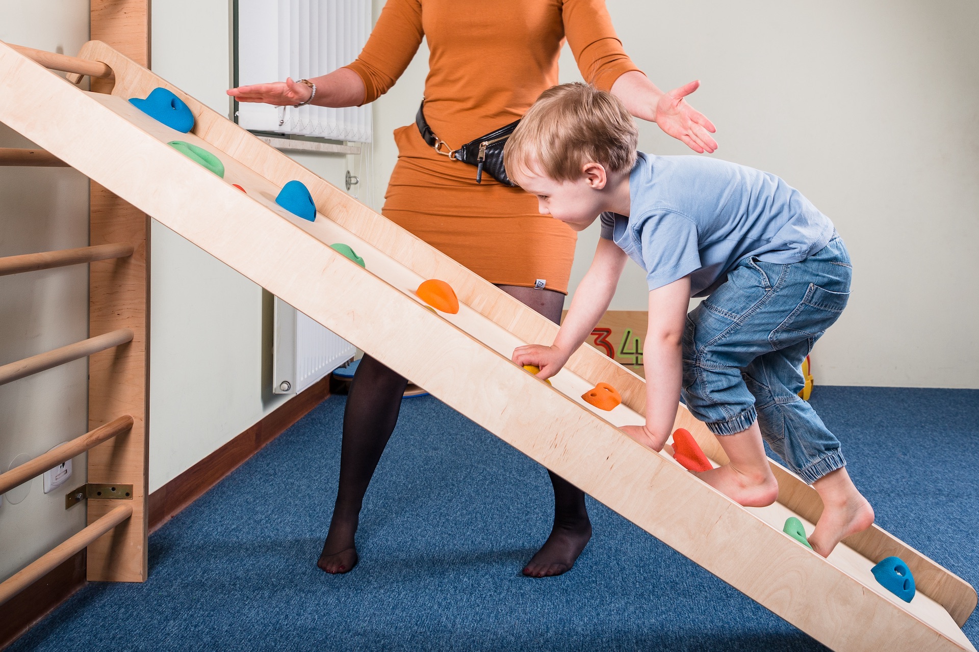 Pediatric Sensory Integration Therapy - a boy on climbing wall